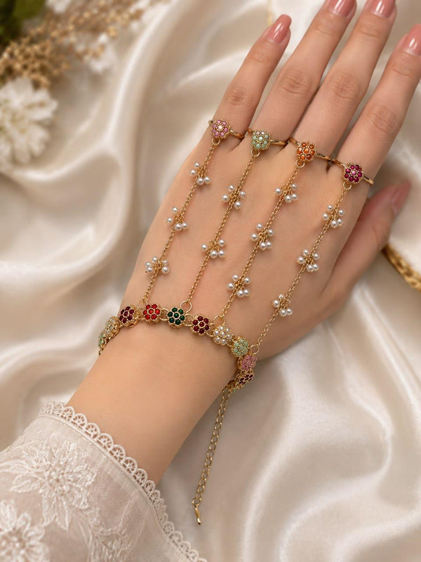 Adjustable gold-tone four-ring hand bracelet with multicolor floral stones and pearl chain details