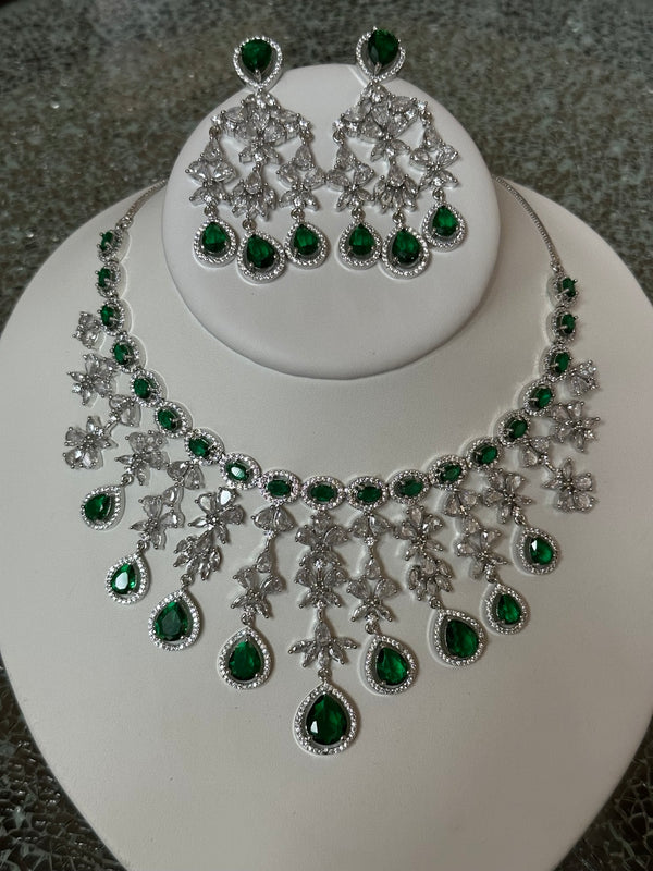 Silver American diamond necklace and earring set with emerald green stones