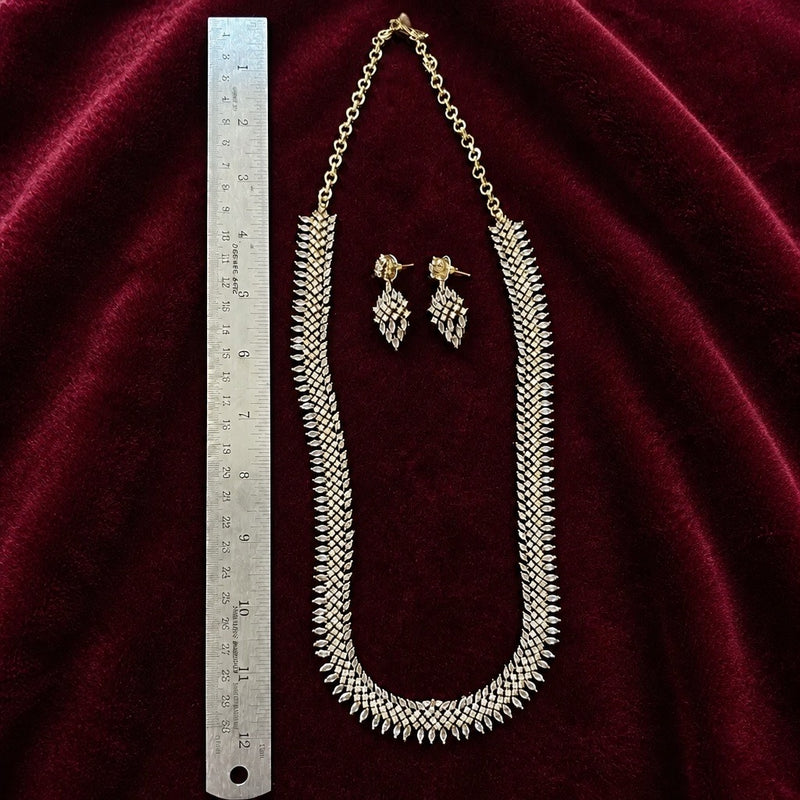 Antique gold American diamond 24 inch necklace set with matching earrings shown beside a ruler