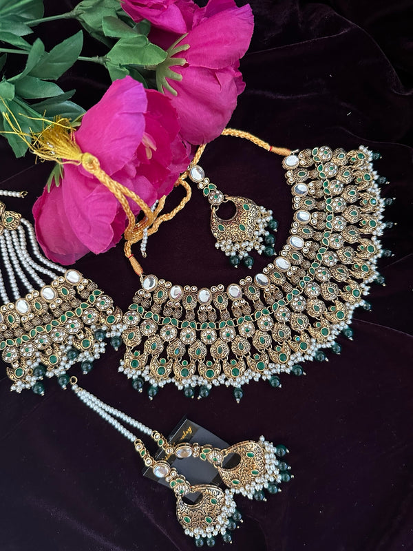 Antique gold bridal necklace set with green stones, jhumar, tikka and earrings