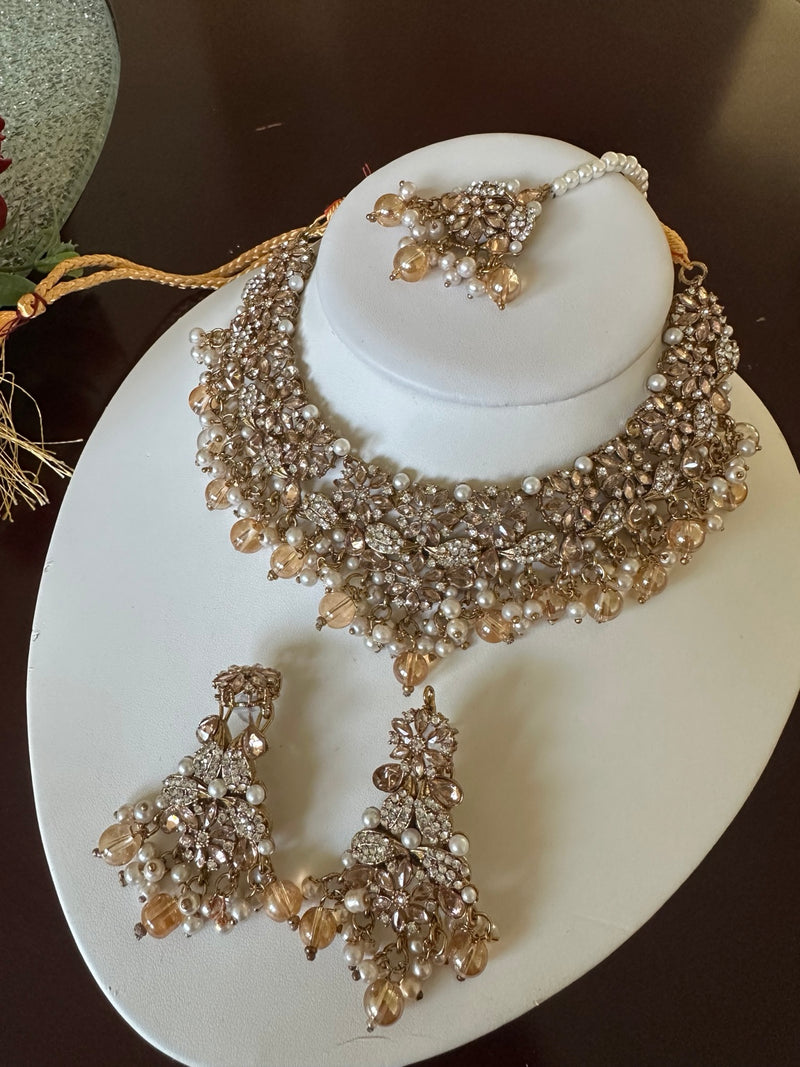 Full view of champagne gold American diamond floral choker necklace set with pearl and crystal bead drops