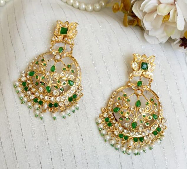Emerald green Kundan chandbali earrings with pearl fringe and gold-tone floral detailing