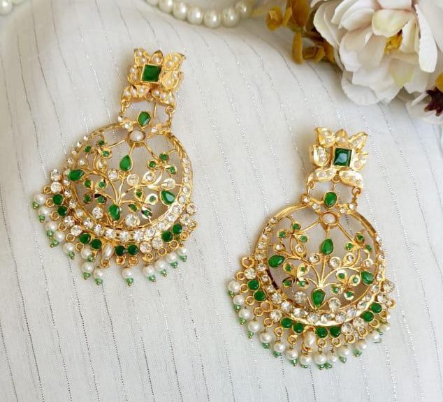 Emerald green Kundan chandbali earrings with pearl fringe and gold-tone floral detailing