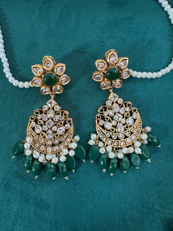 Emerald green kundan chandbali earrings shown on hand