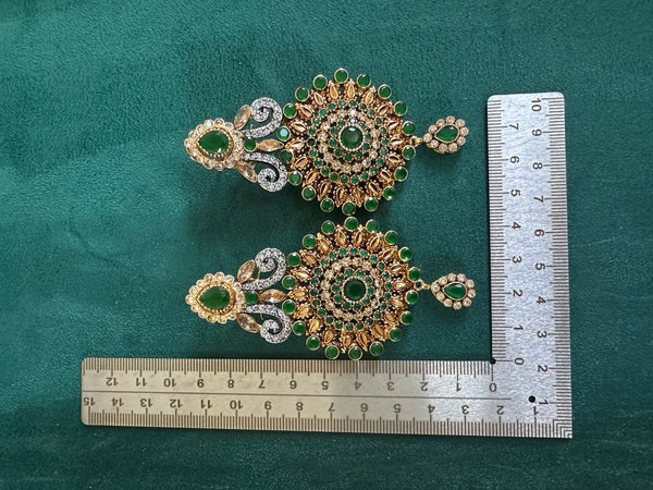 Emerald green statement earrings with measurement ruler