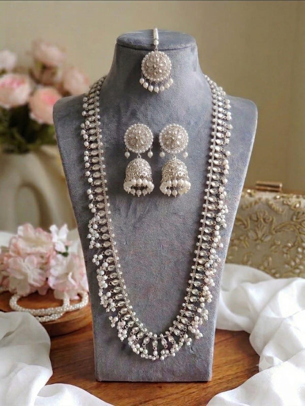 Silver Pakistani long mala jewelry set displayed on necklace bust with earrings and tikka