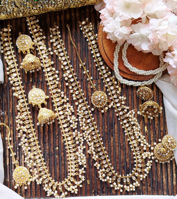 Gold long mala necklace set with matching jhumka earrings and tikka for desi bridal wear