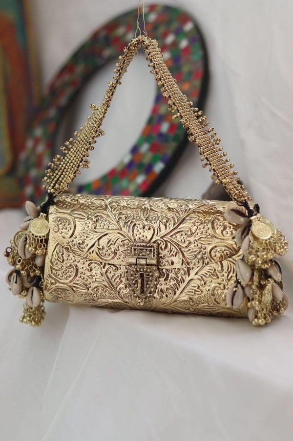 Hand carved metal clutch with beaded strap and gold antique finish