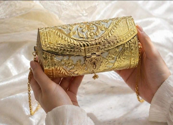 Hand carved gold metal clutch with chain strap and black velvet lining