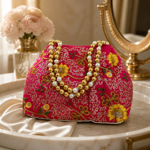 Handcrafted hot pink floral fabric clutch with pearl and gold bead handle
