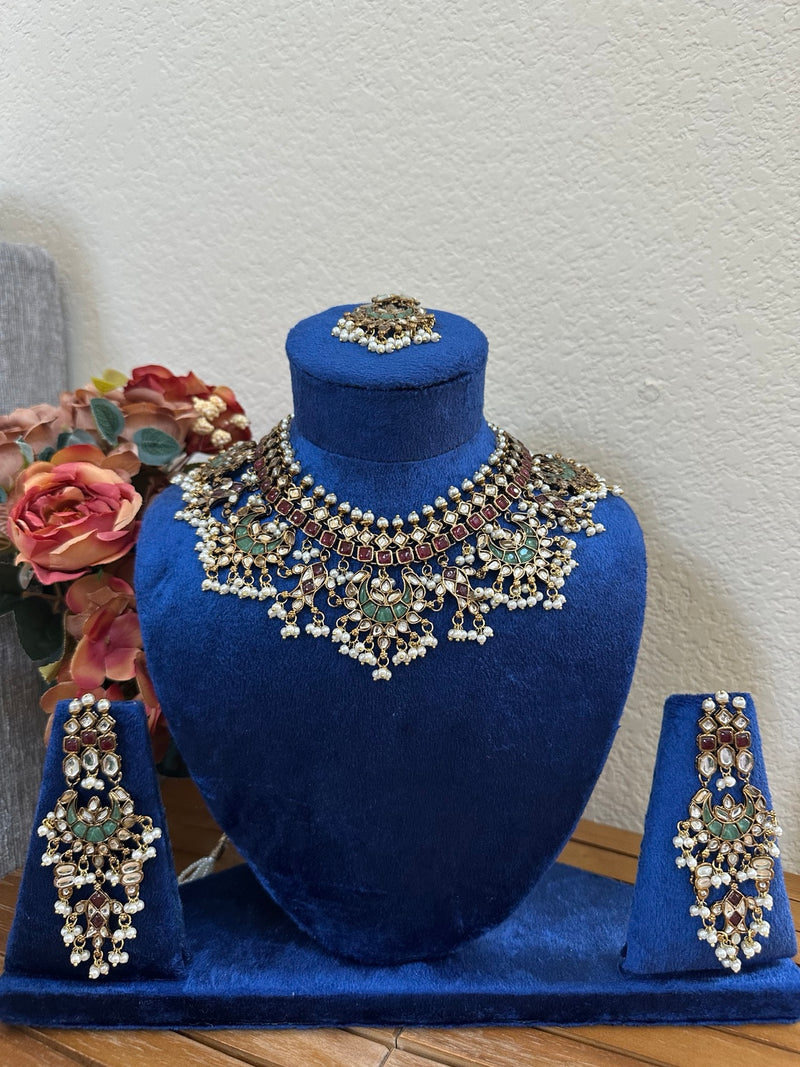 Multicolor kundan bridal necklace and earrings set on royal blue velvet bust