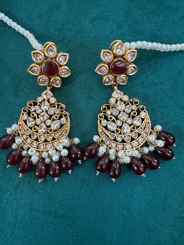 Ruby kundan chandbali earrings close up with pearl bead detailing