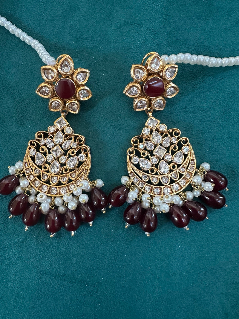 Ruby kundan chandbali earrings close up with pearl bead detailing