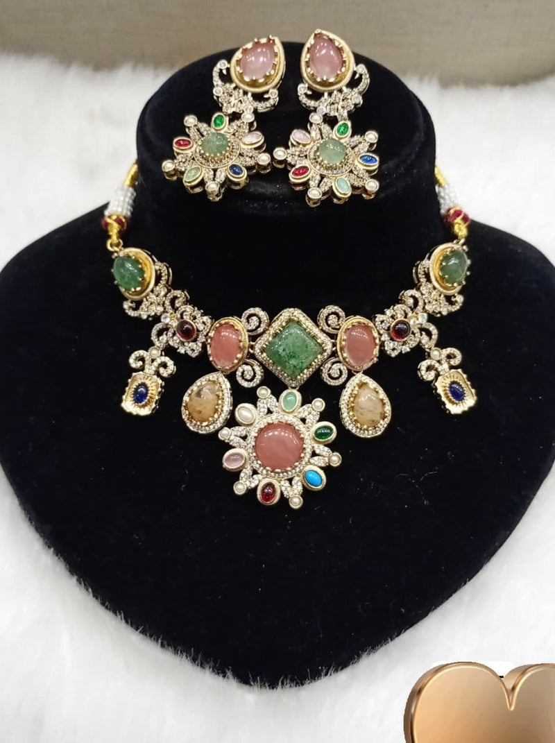 Multicolor gemstone statement necklace set with matching earrings displayed on a black velvet jewelry bust