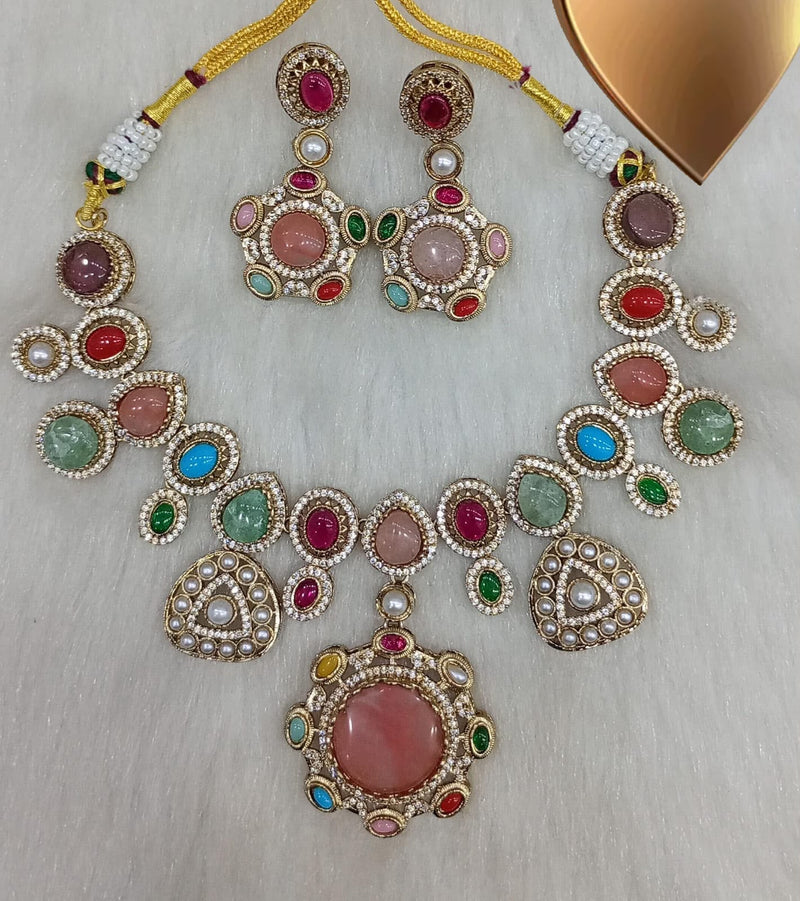 Multicolor pink cabochon gemstone statement necklace set with matching earrings and large round pendant displayed on a white background