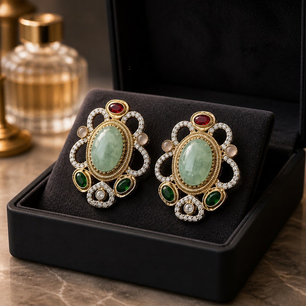 Oval stud earrings with mint center stone and emerald green accents in luxury box