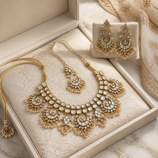 Pearl white kundan bridal jewelry set with necklace earrings and tikka in box display