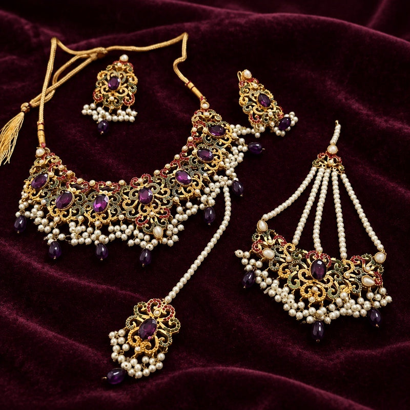 Gold-tone purple stone necklace set with pearl-style fringe, matching earrings, maang tikka and jhoomar displayed on burgundy velvet.