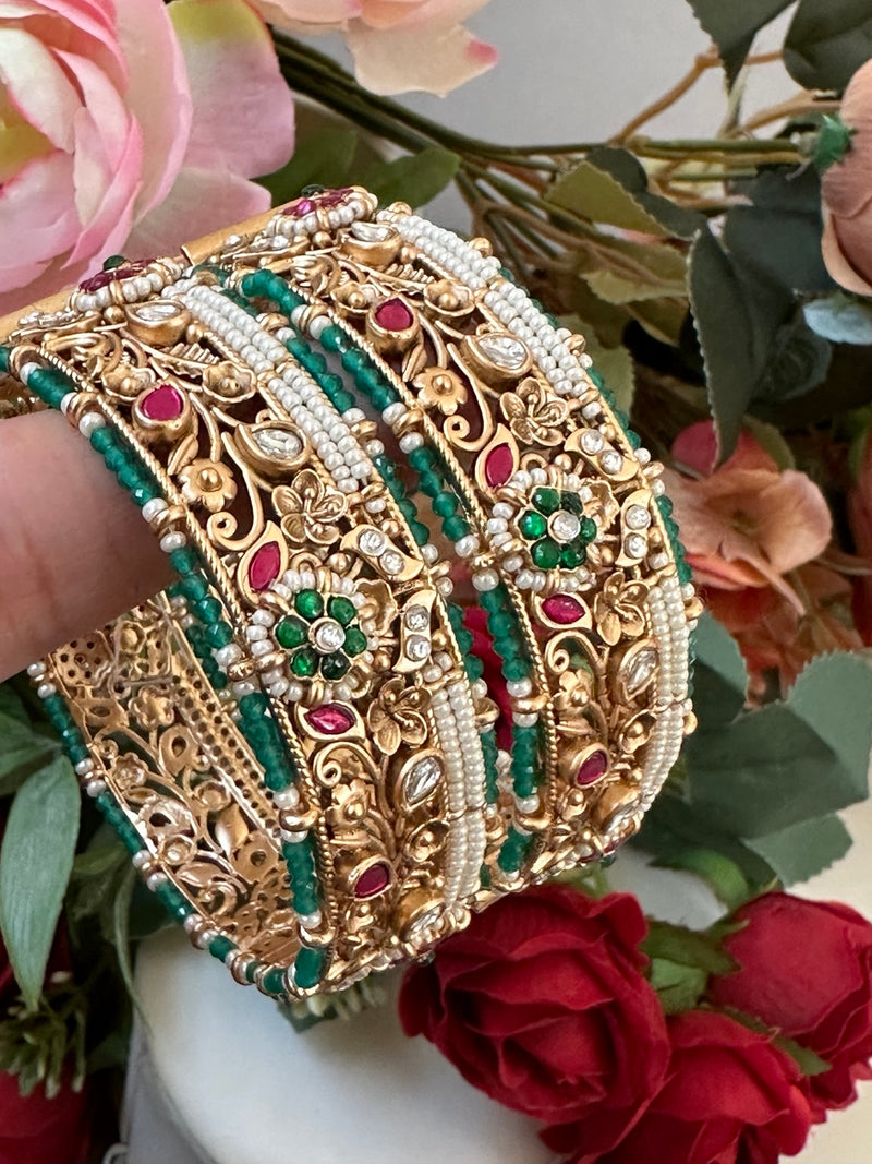 Rajwari bangle set of 2 in antique gold with green beads, pink stones, kundan details and pearl accents