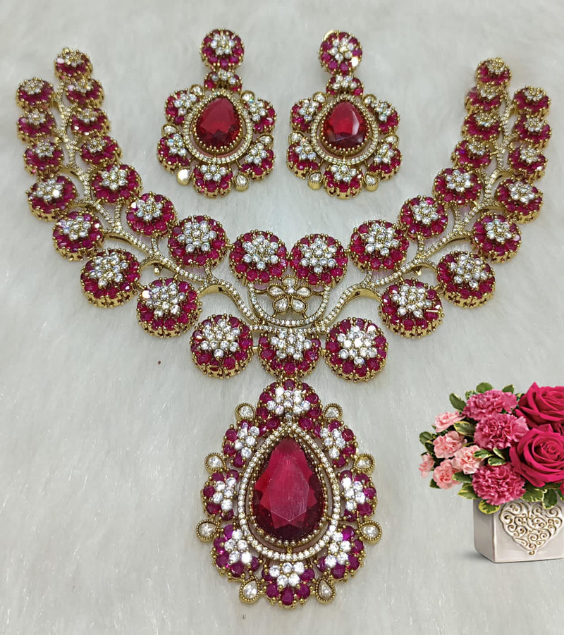 Ruby red floral statement necklace set with matching earrings and oversized teardrop pendant displayed on a white background