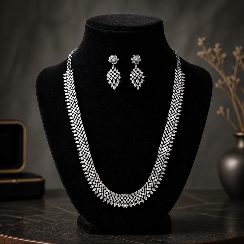 Silver American diamond necklace set with matching earrings displayed on a black jewelry bust