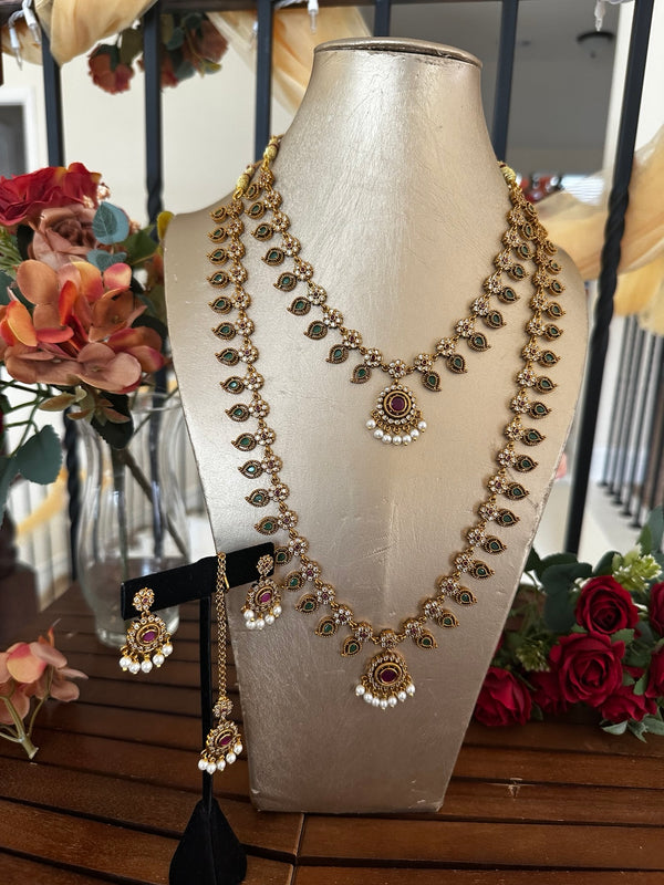South Indian green stone jewelry set with two necklaces, matching earrings and tikka